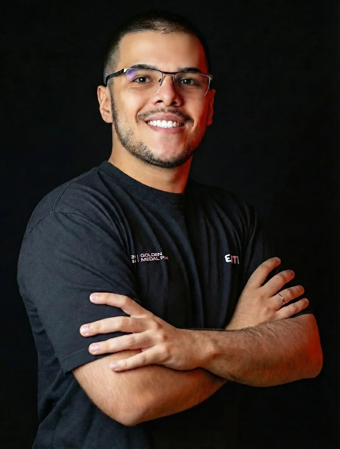 Gustavo Manrrik, sorrindo, de óculos e braços cruzados